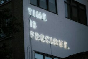 a neon sign that reads time is precious