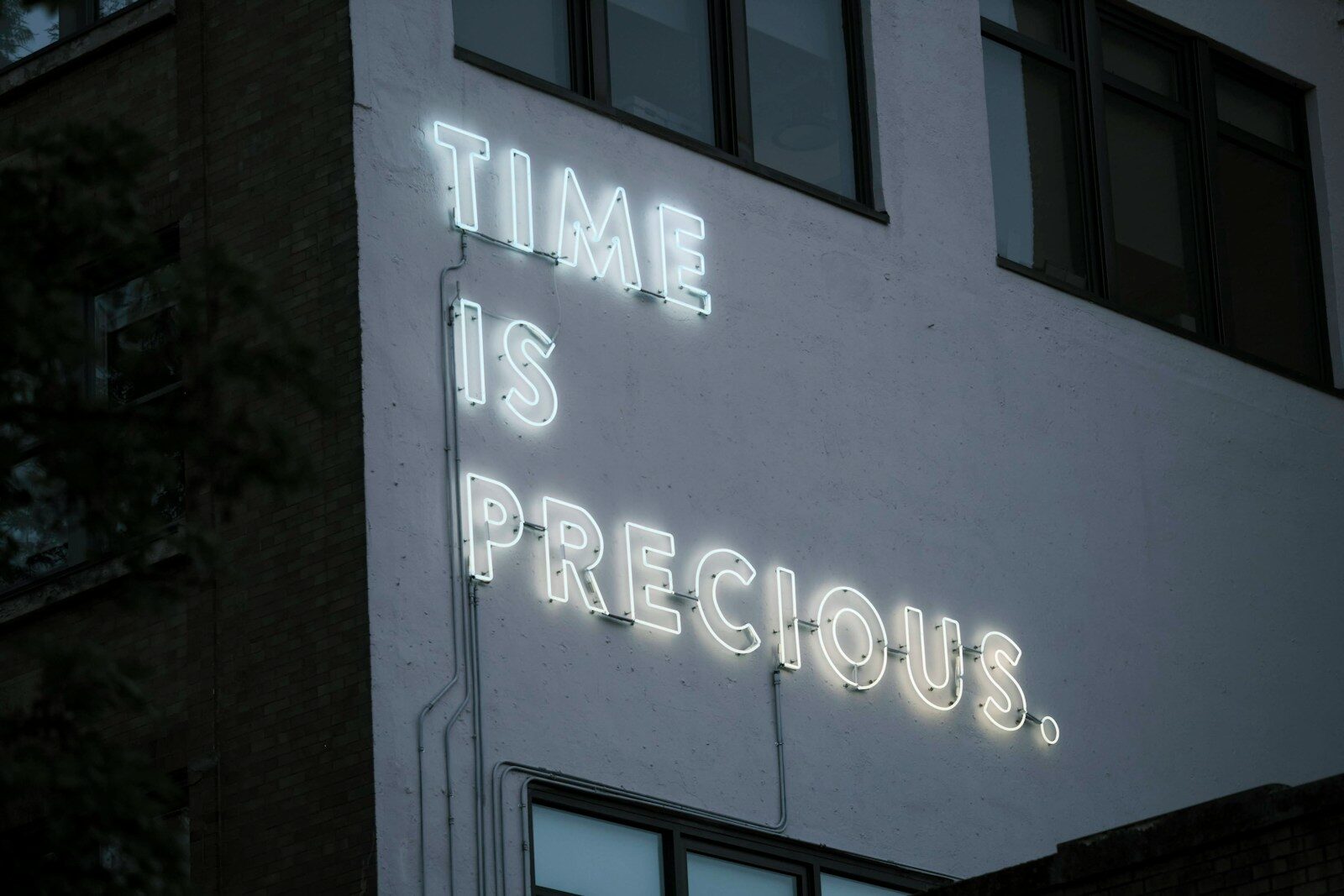 a neon sign that reads time is precious
