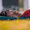 a woman laying on the ground with her eyes closed